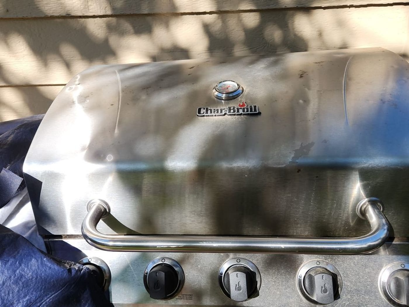Stainless steel grill lid dented by hail during a Centennial storm inspection
