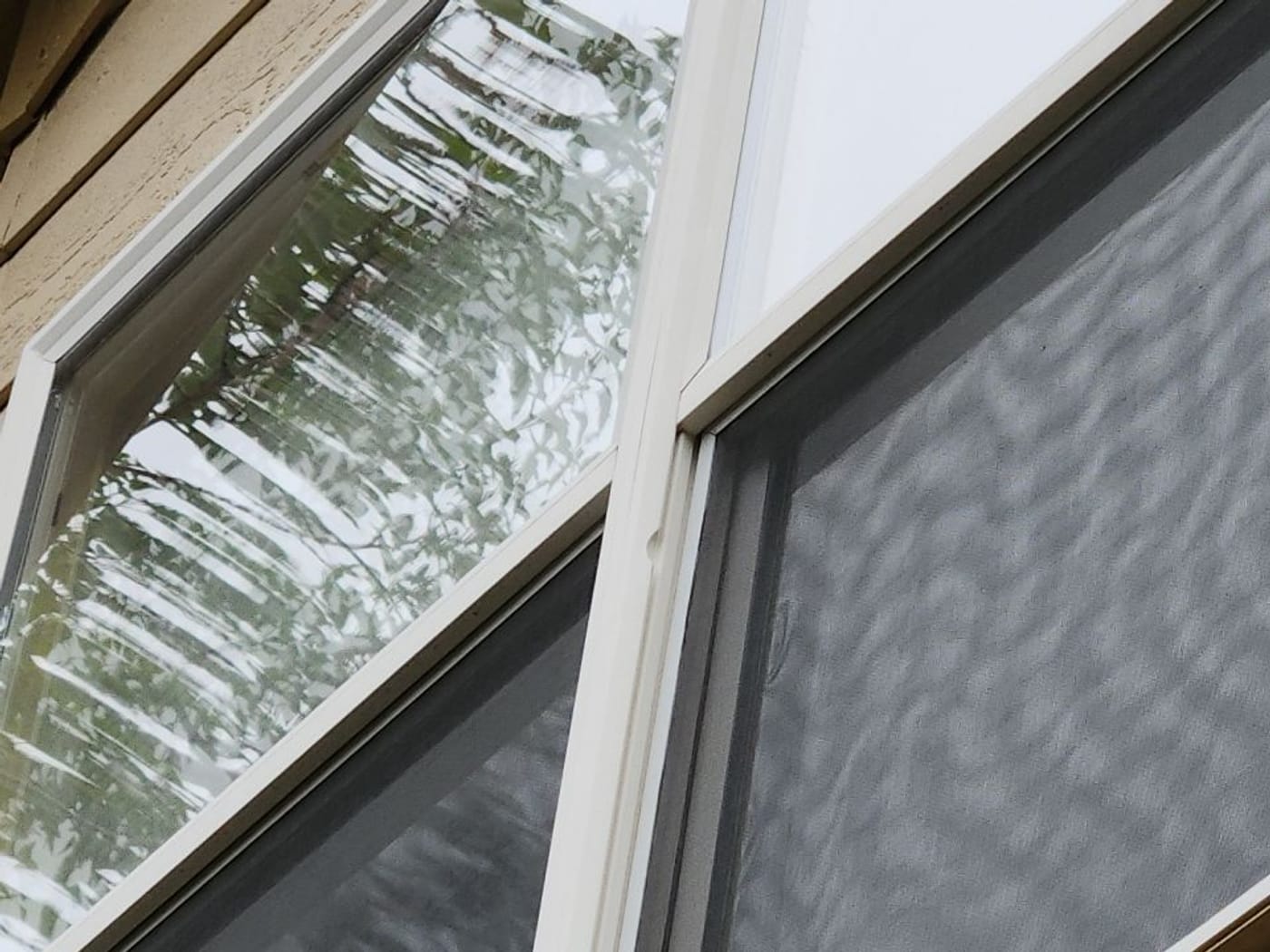 Half-moon hail strikes on a home's window and screen in Centennial