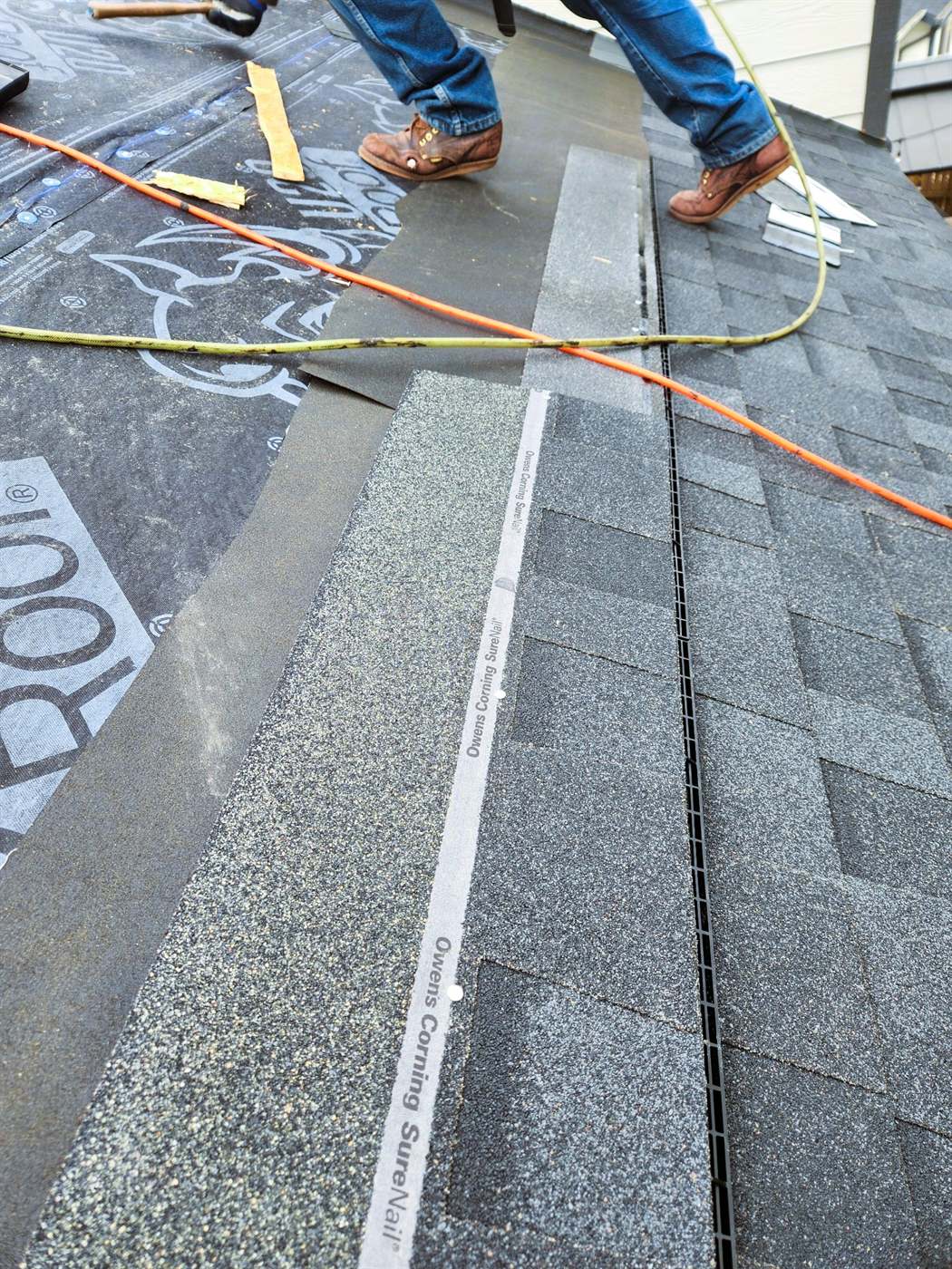 Bailey Roofing crew shingling over a new low-profile rooftop intake vent with Owens Corning SureNail shingles, September 2024