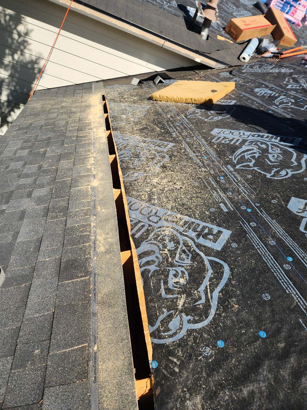Intake vent slot cut into the roof over RhinoRoof U20 synthetic underlayment during a Bailey Roofing replacement, September 2024