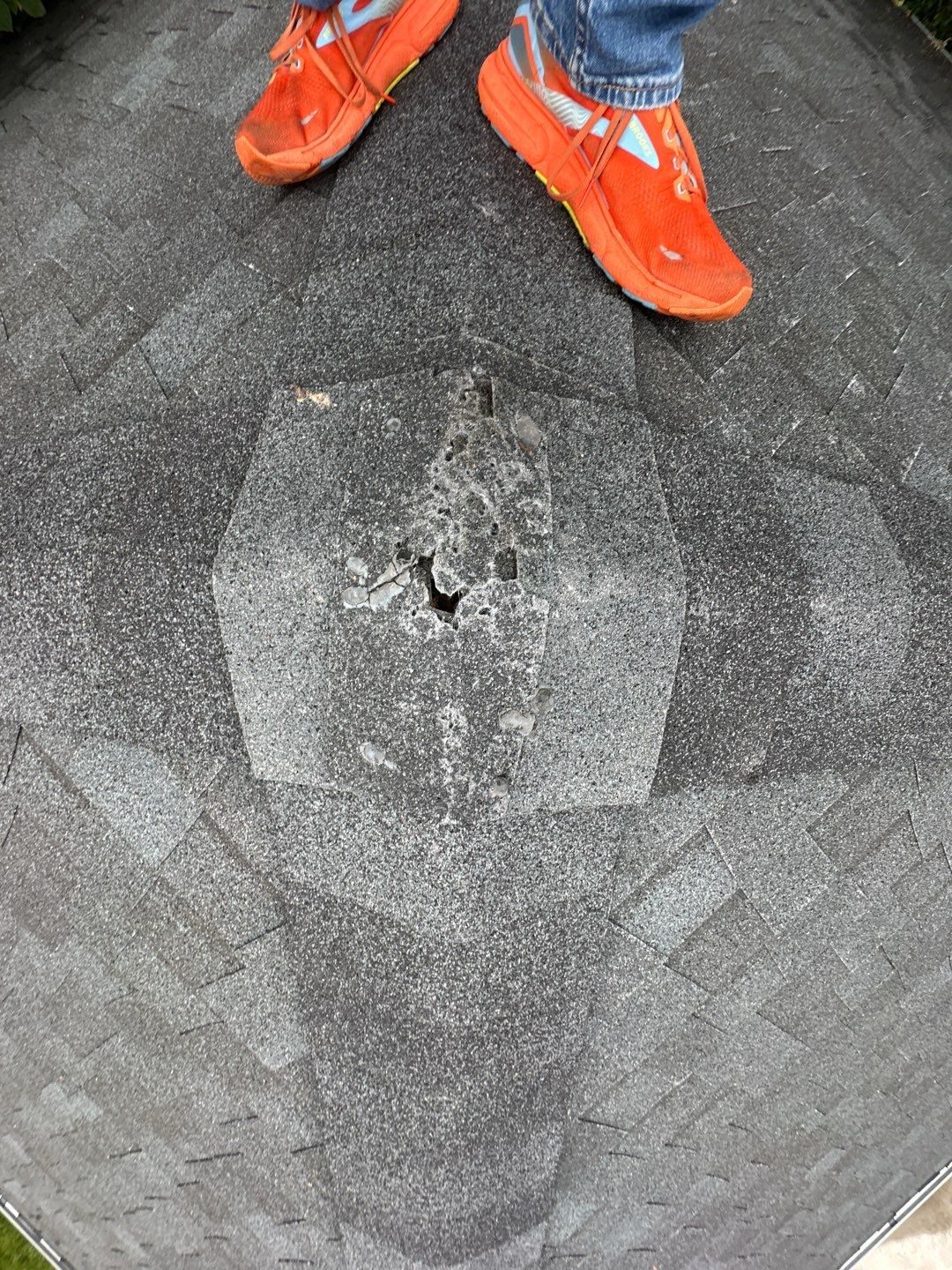 Deteriorated shingle patch with exposed hole documented by Bailey Roofing before repair, February 2026