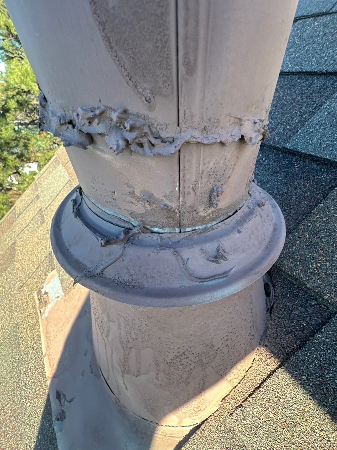 Failed pipe boot with cracked sealant found during a Bailey Roofing inspection, February 2026