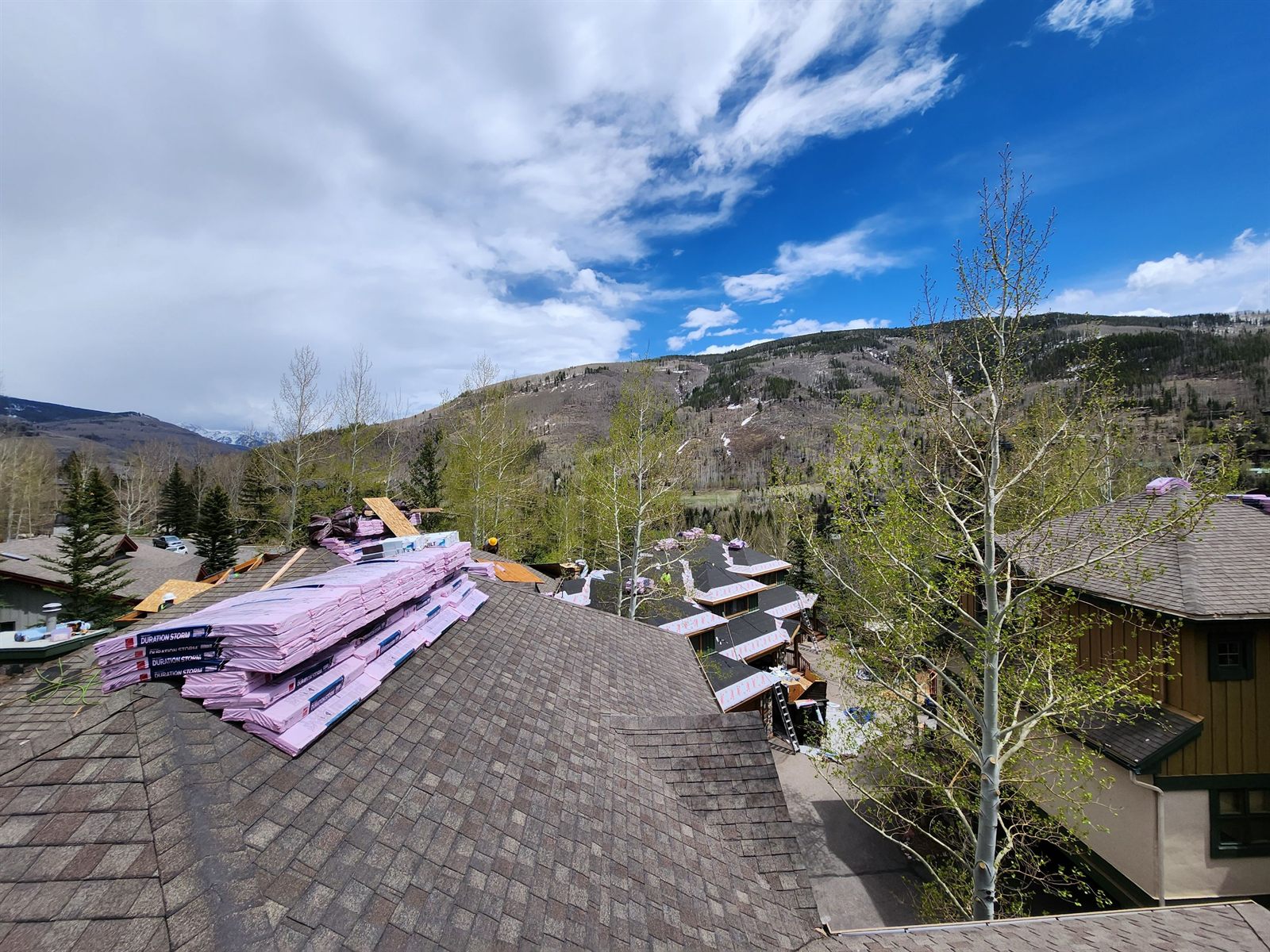 Owens Corning Duration Storm shingle bundles staged on the Chateau Tremonte condominium reroof by Bailey Roofing in Vail, May 2023