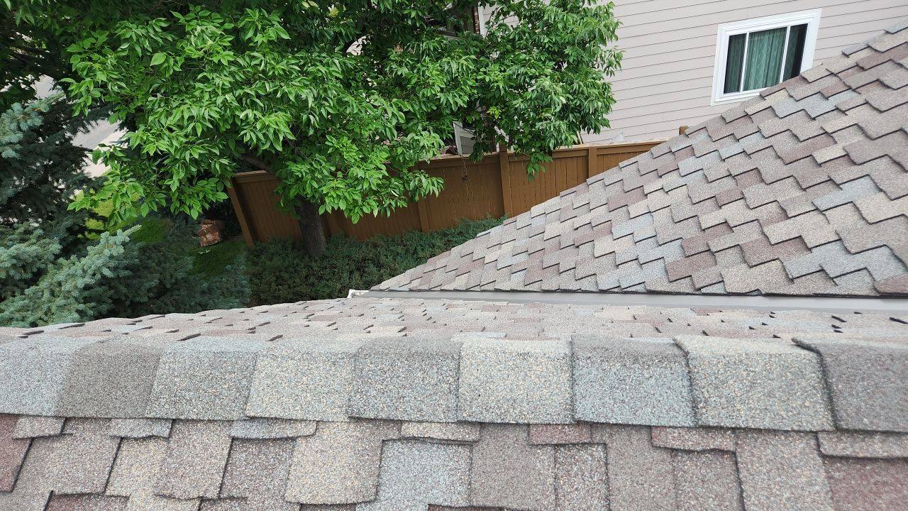 Close-up of finished CertainTeed Presidential shingles at the ridge on an East Powers Drive roof replaced by Bailey Roofing in Centennial, July 2023