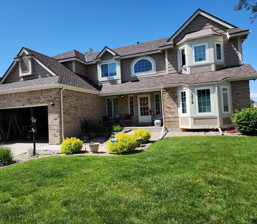 Finished CertainTeed roof replacement by Bailey Roofing on a stone-and-stucco two-story on East Powers Drive, Piney Creek, Centennial, June 2023