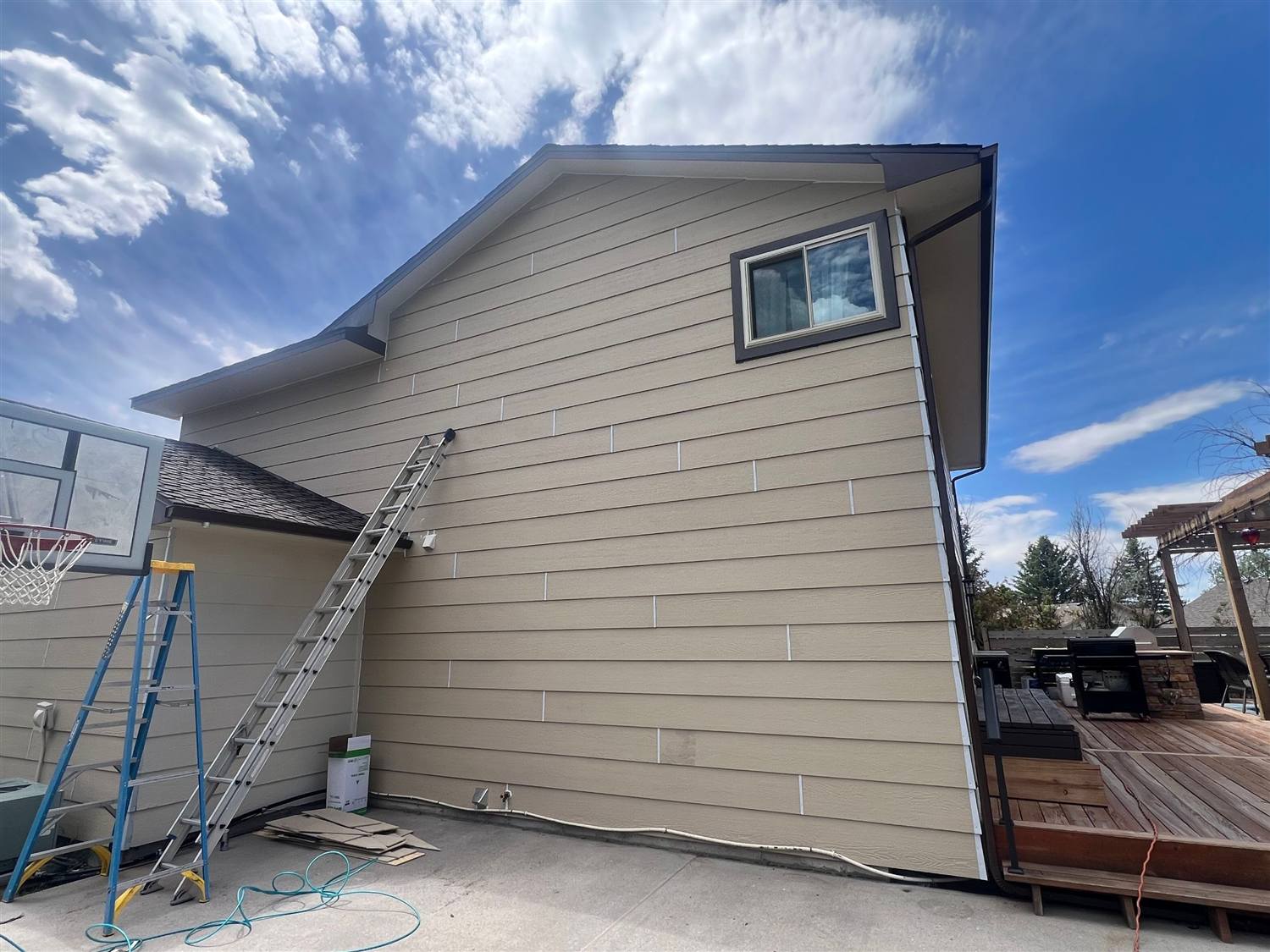 New LP Prime 12-inch lap siding and dark trim installed by Bailey Roofing on the same wall in Cheyenne, Wyoming, June 2026