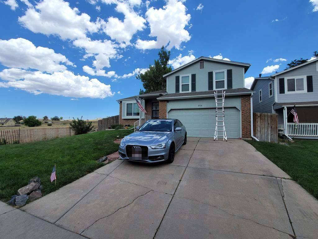 Same Parker tri-level with new sage-green LP SmartSide engineered wood siding and shutters installed by Bailey Roofing, July 2026